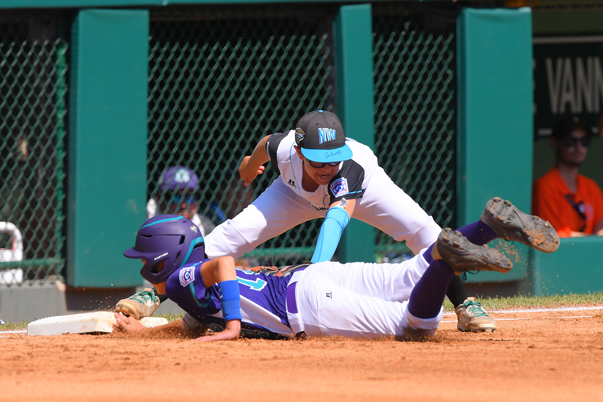 nw first baseman tagging out sliding player