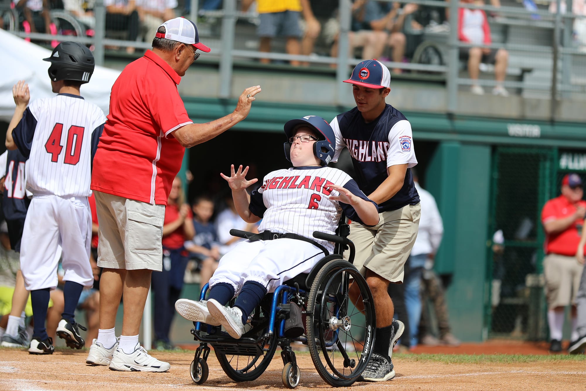 challenger game - buddy pushing player in wheelchair home