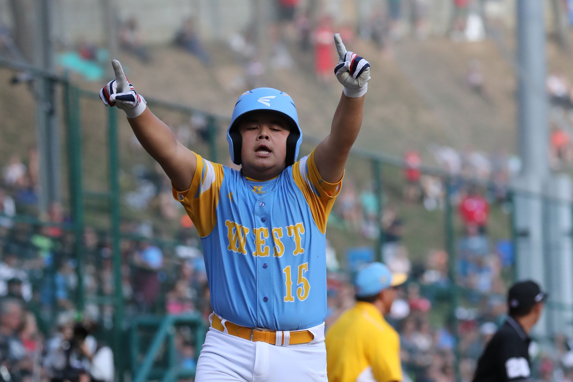 west player running home with hands in the air