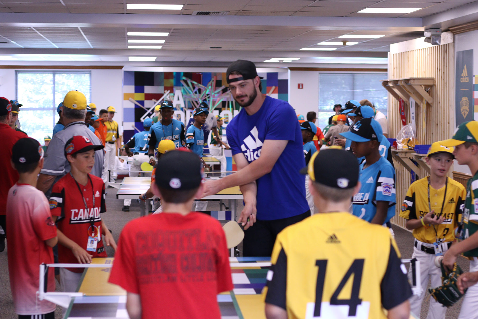 Cubs player playing ping pong with teams