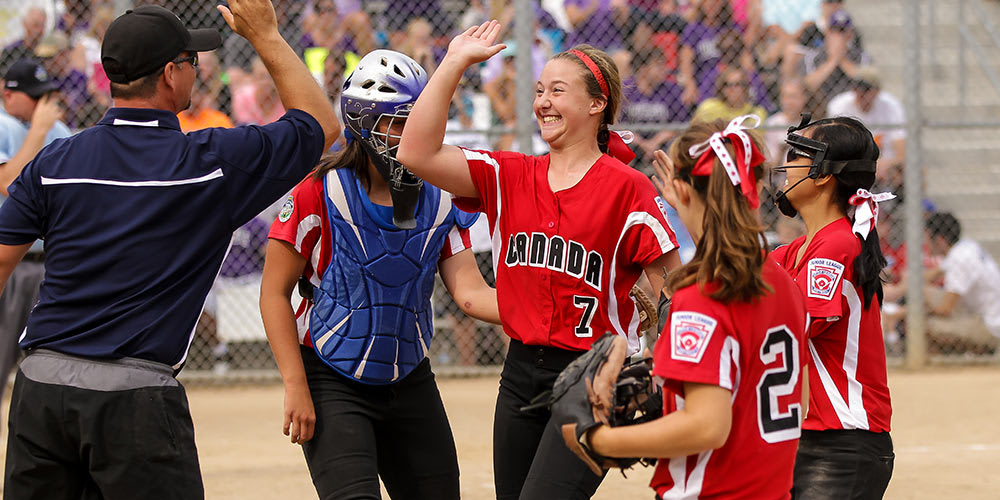 coach-high-fiving-softball-team