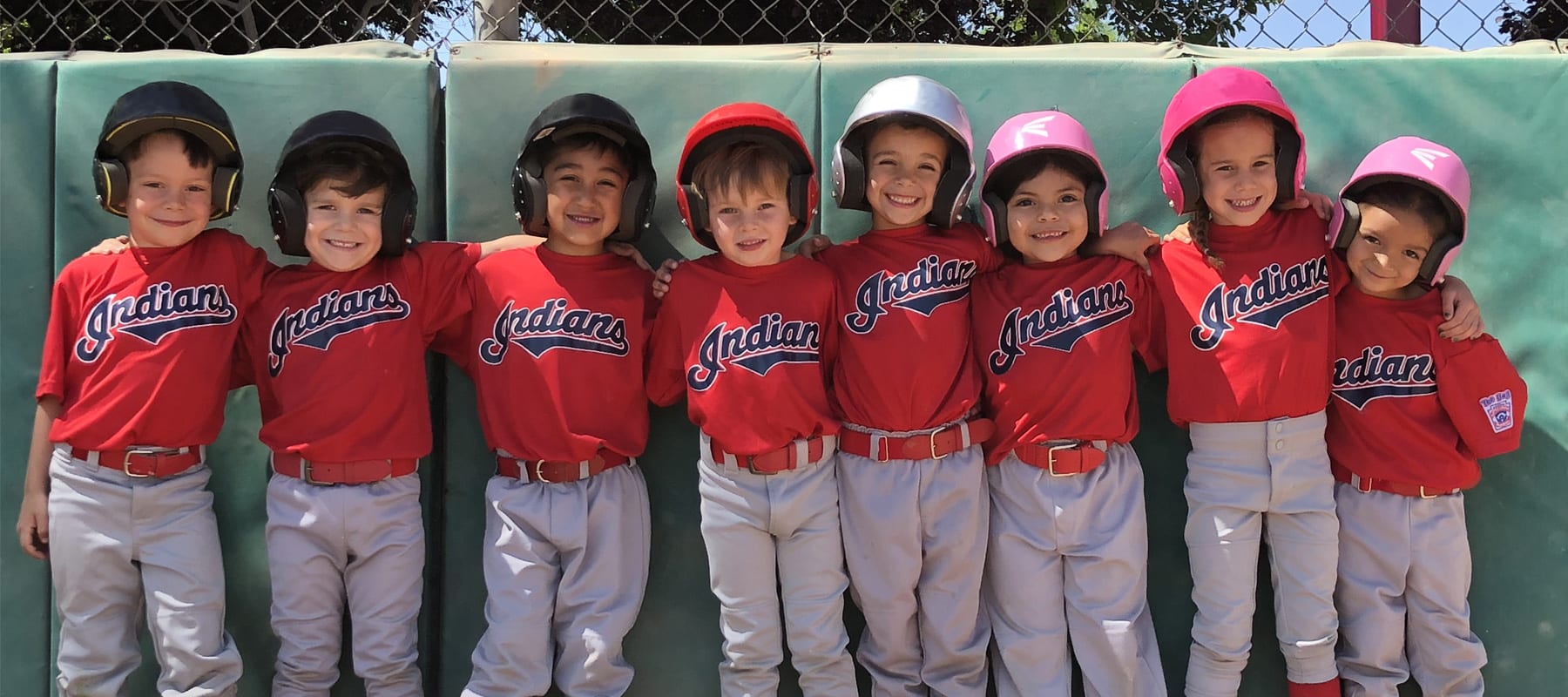 Four Young Little League Baseball Players in Red and White Team Uniforms  watching Game of Softball / Hardball at Ball Park Stock Photo - Alamy