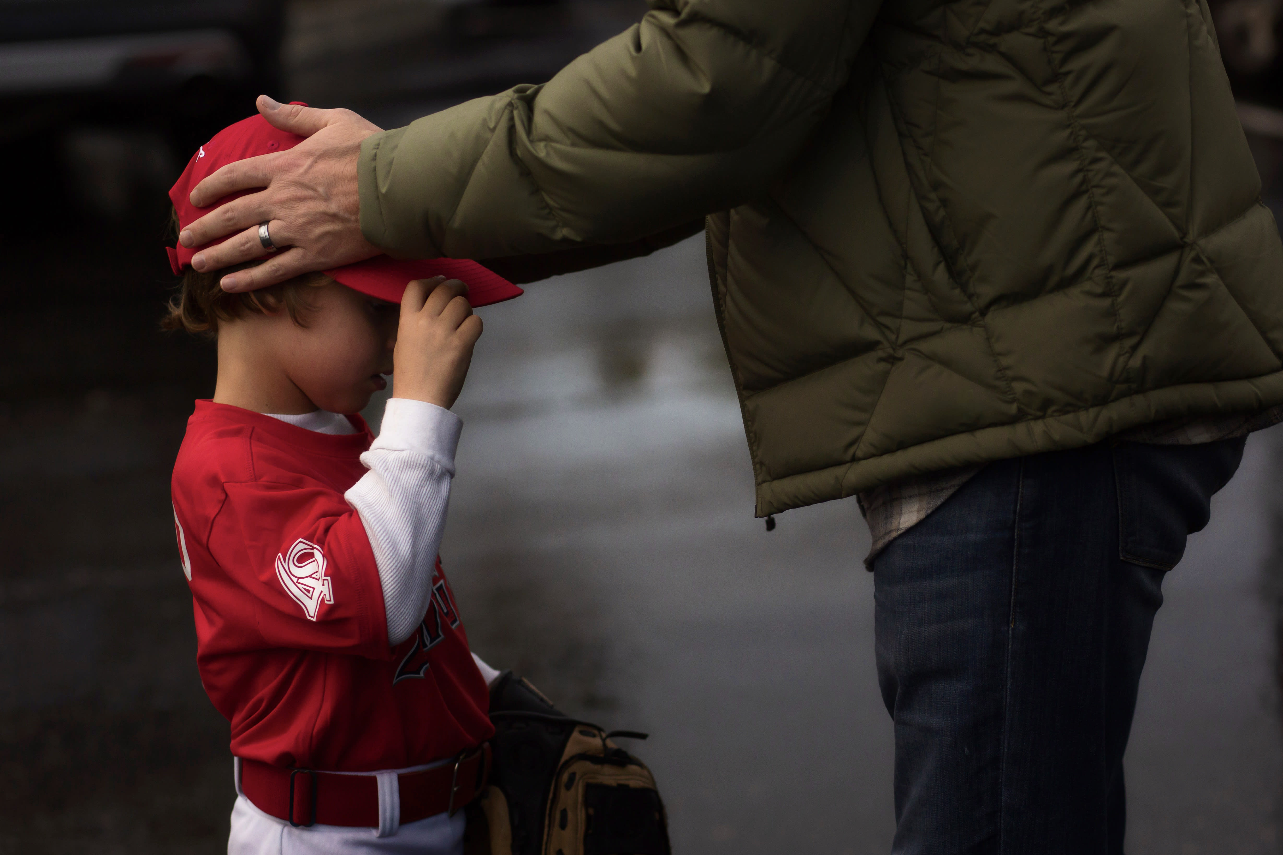 Tee Ball child with dad holding head