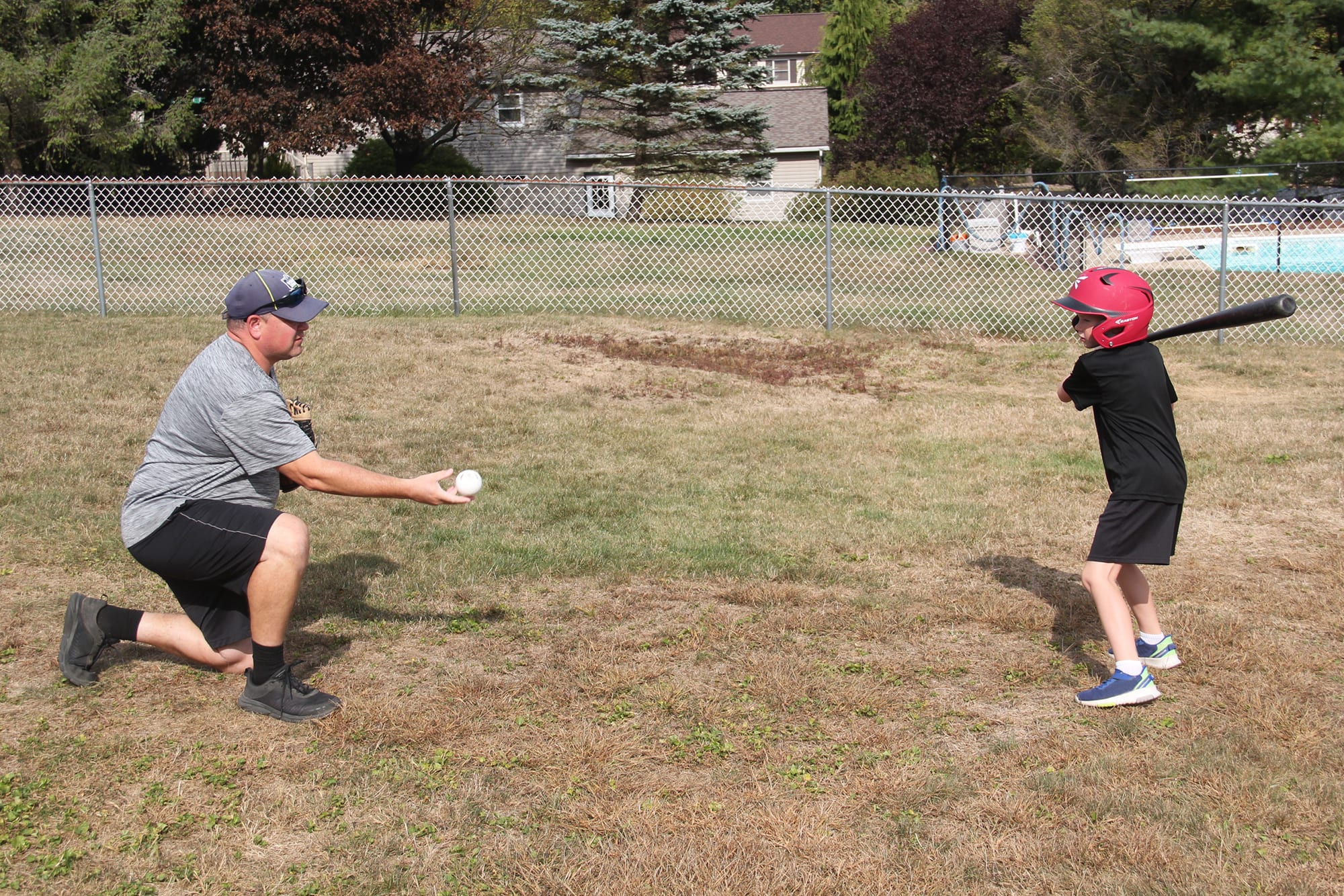 father tossing ball