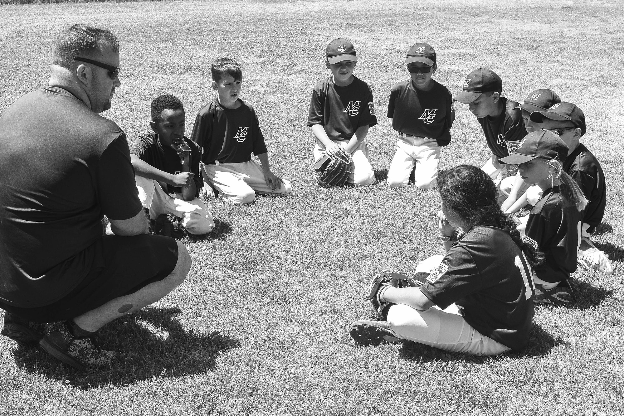 coach talking to players bw