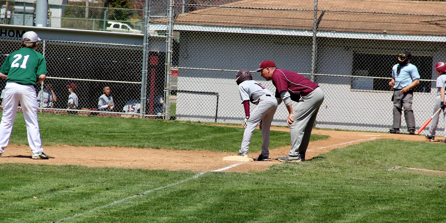 third base coach talking to runner