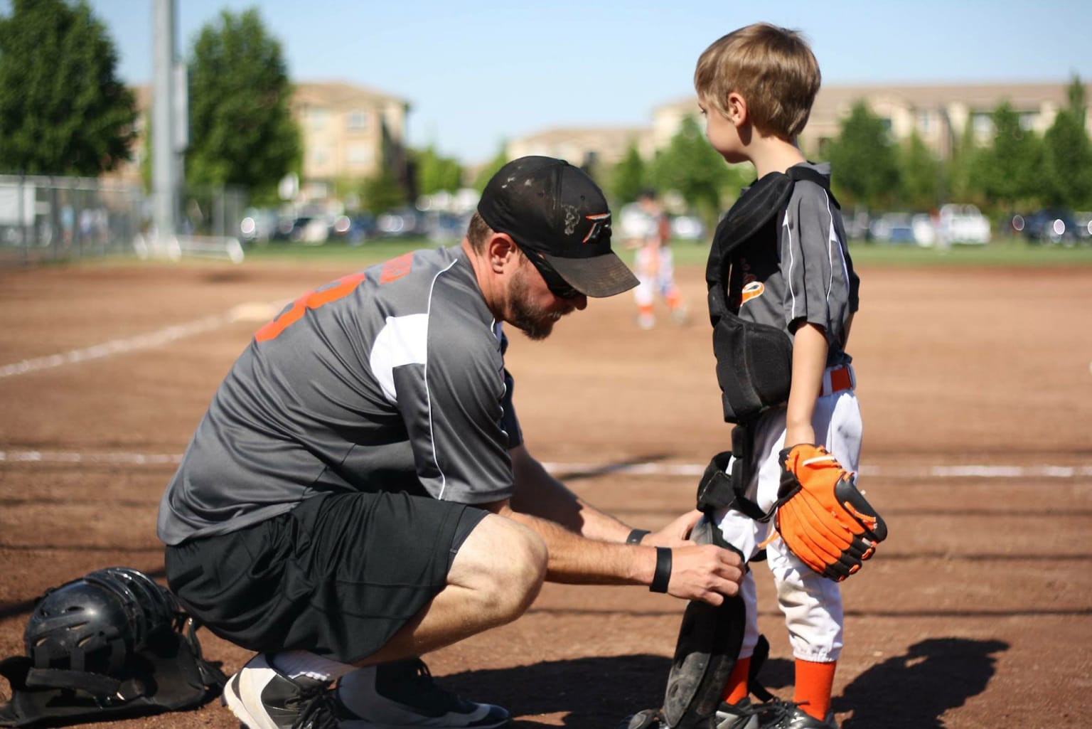 coach helping player with gear