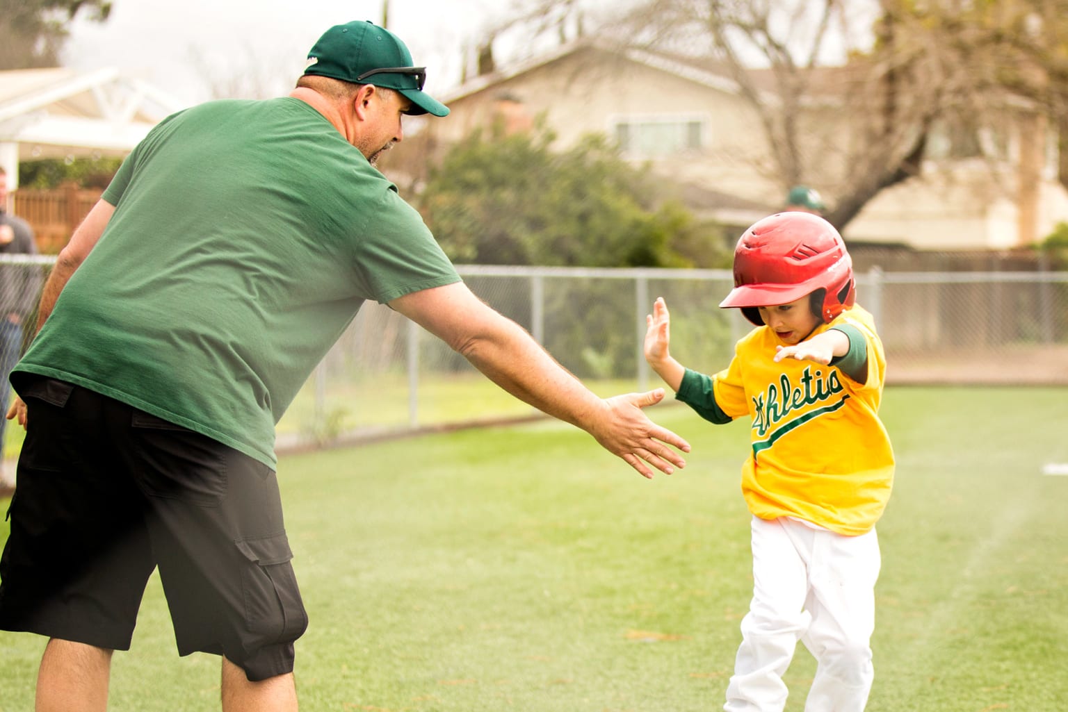 coach-high-fiving-baserunner