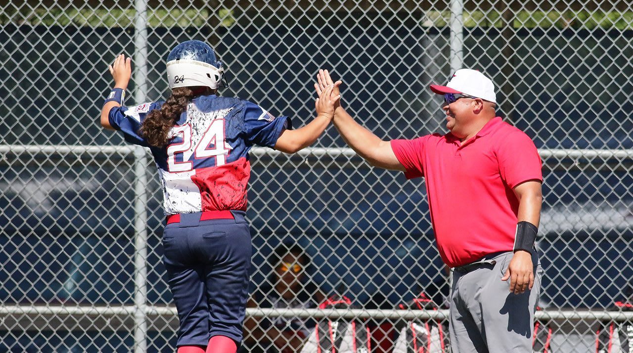 Coach and player high-fiving