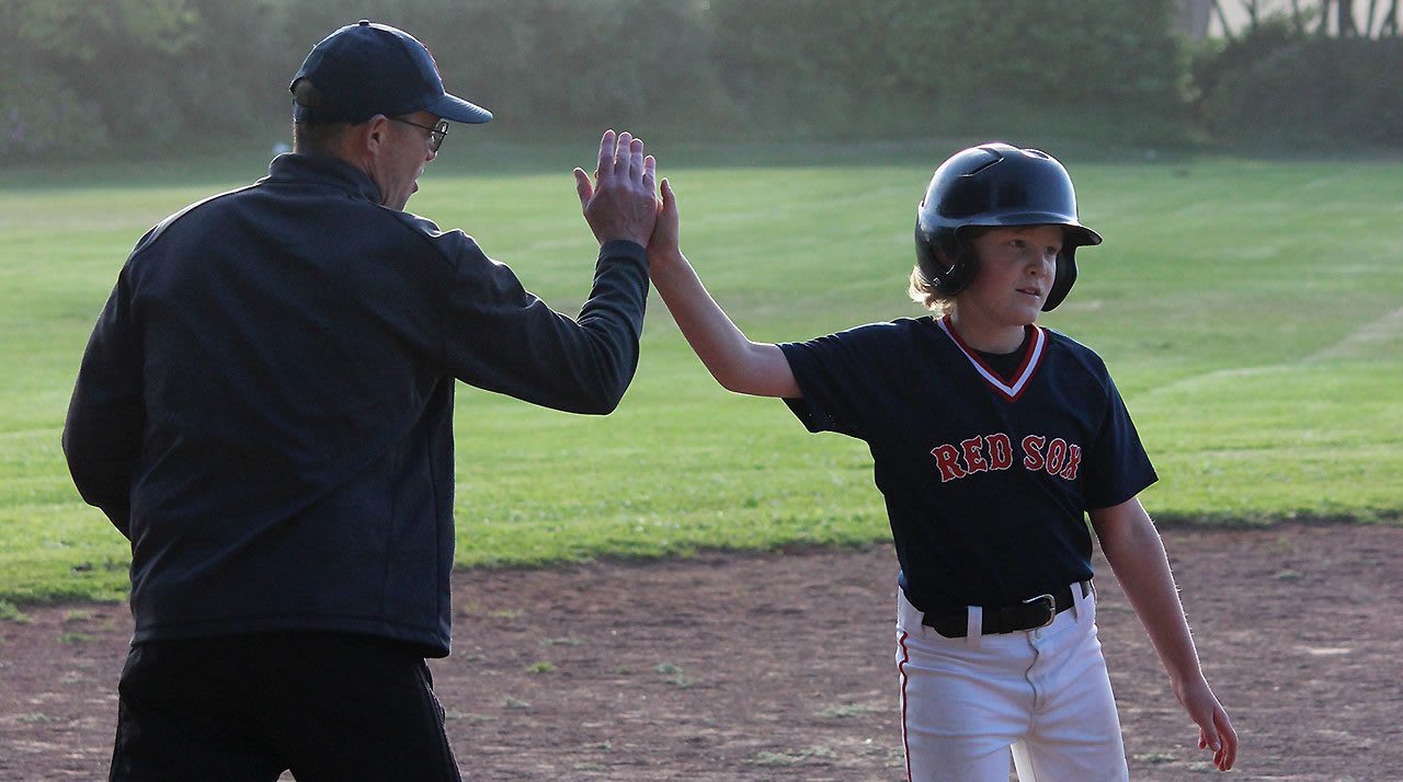 Coach and Baseball Player High-fiving
