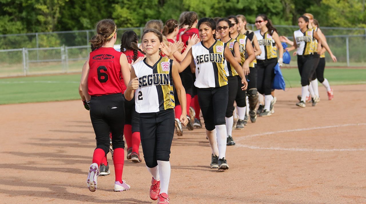 Softball players high-fiving