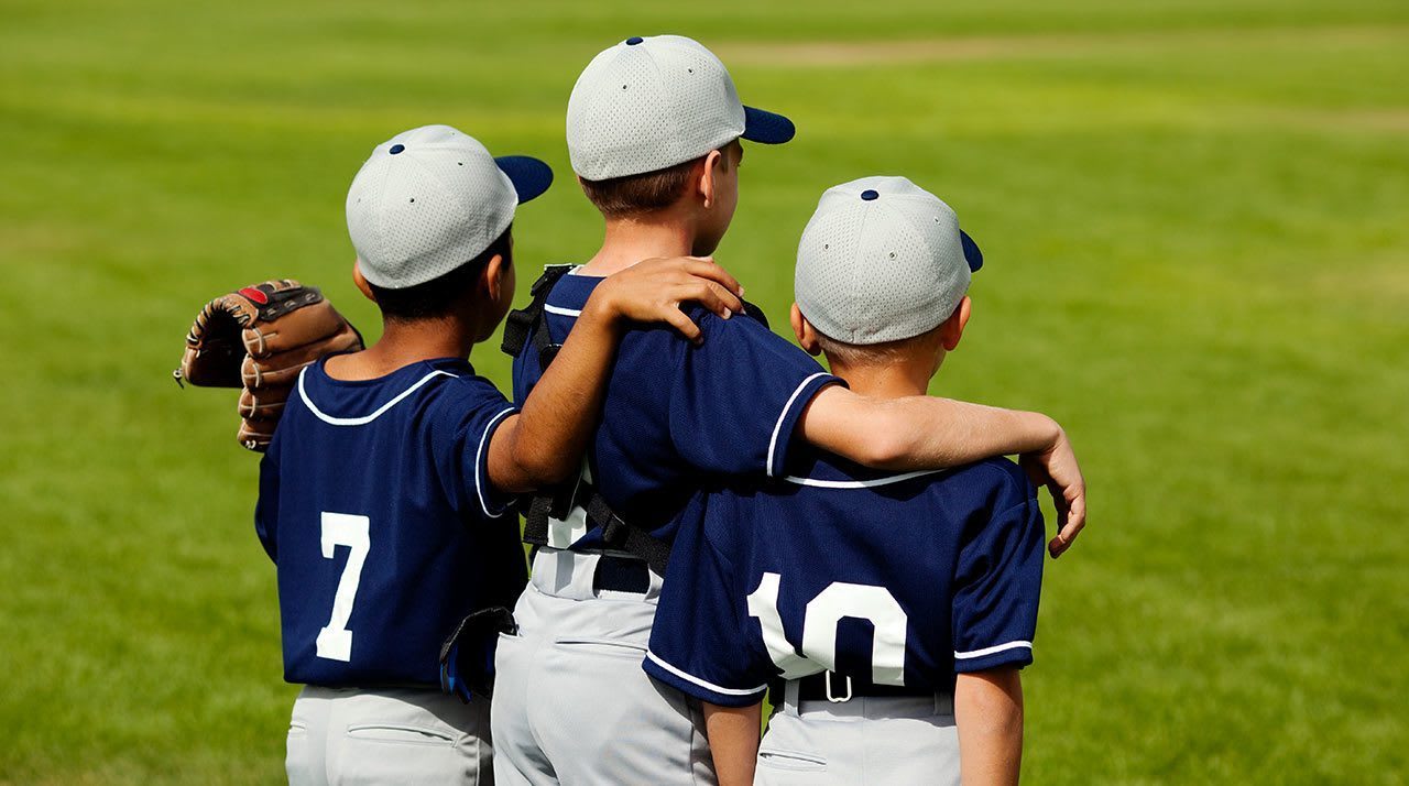baseball players standing next to each other