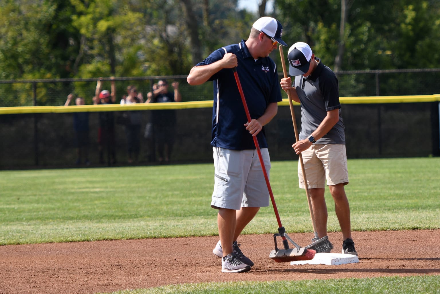 volunteers sweeping field