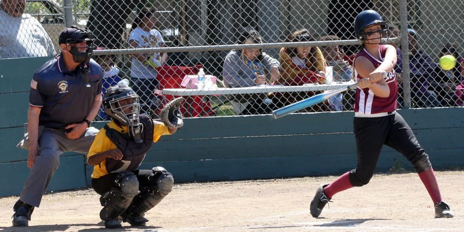 softball player swinging bat