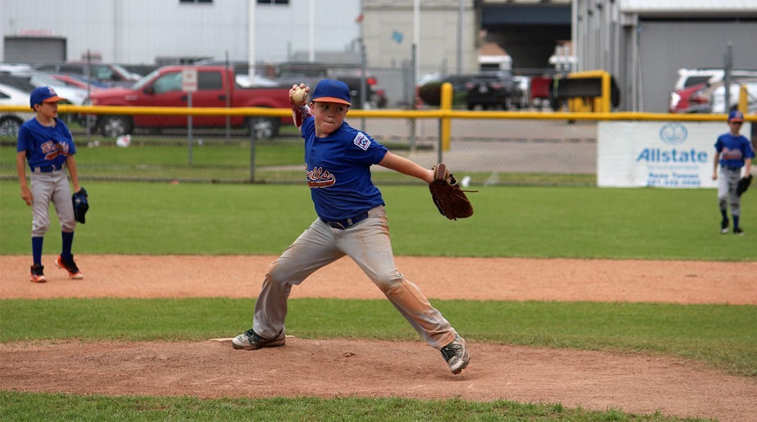 Little league baseball pitcher in wind up throwing the ball. Stock