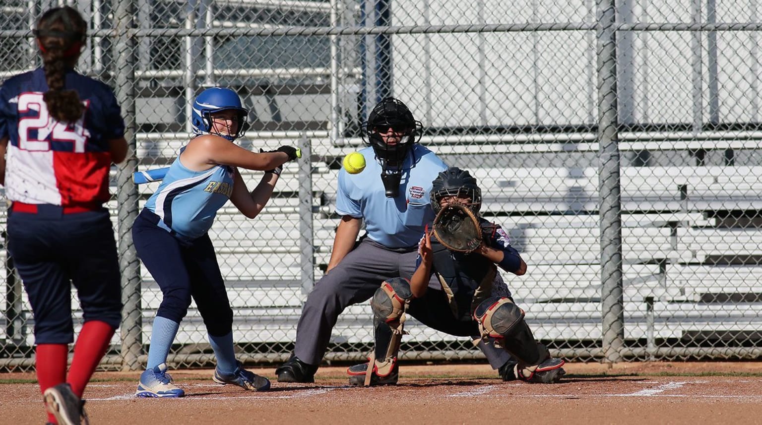 softball player swinging bat