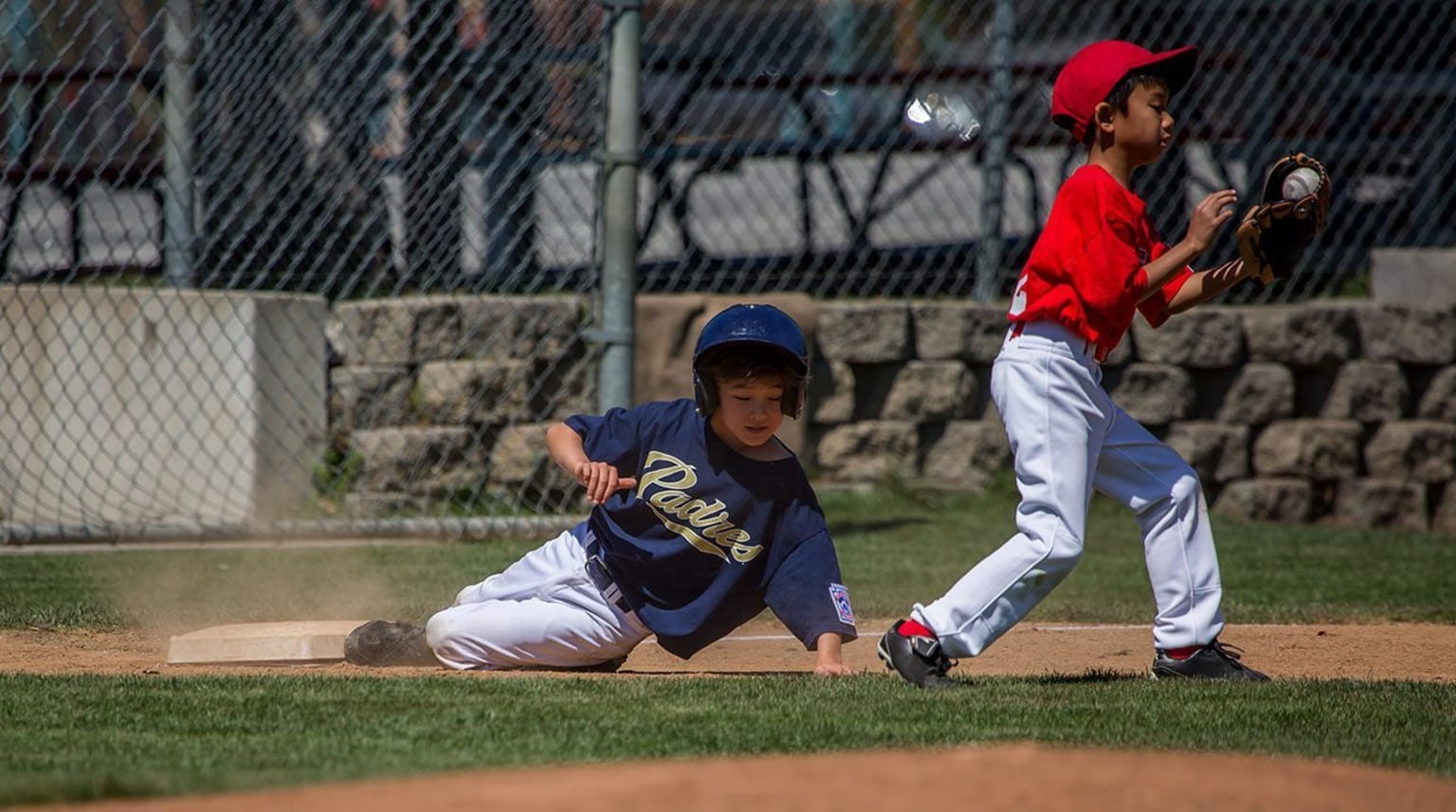 Baseball player sliding onto base