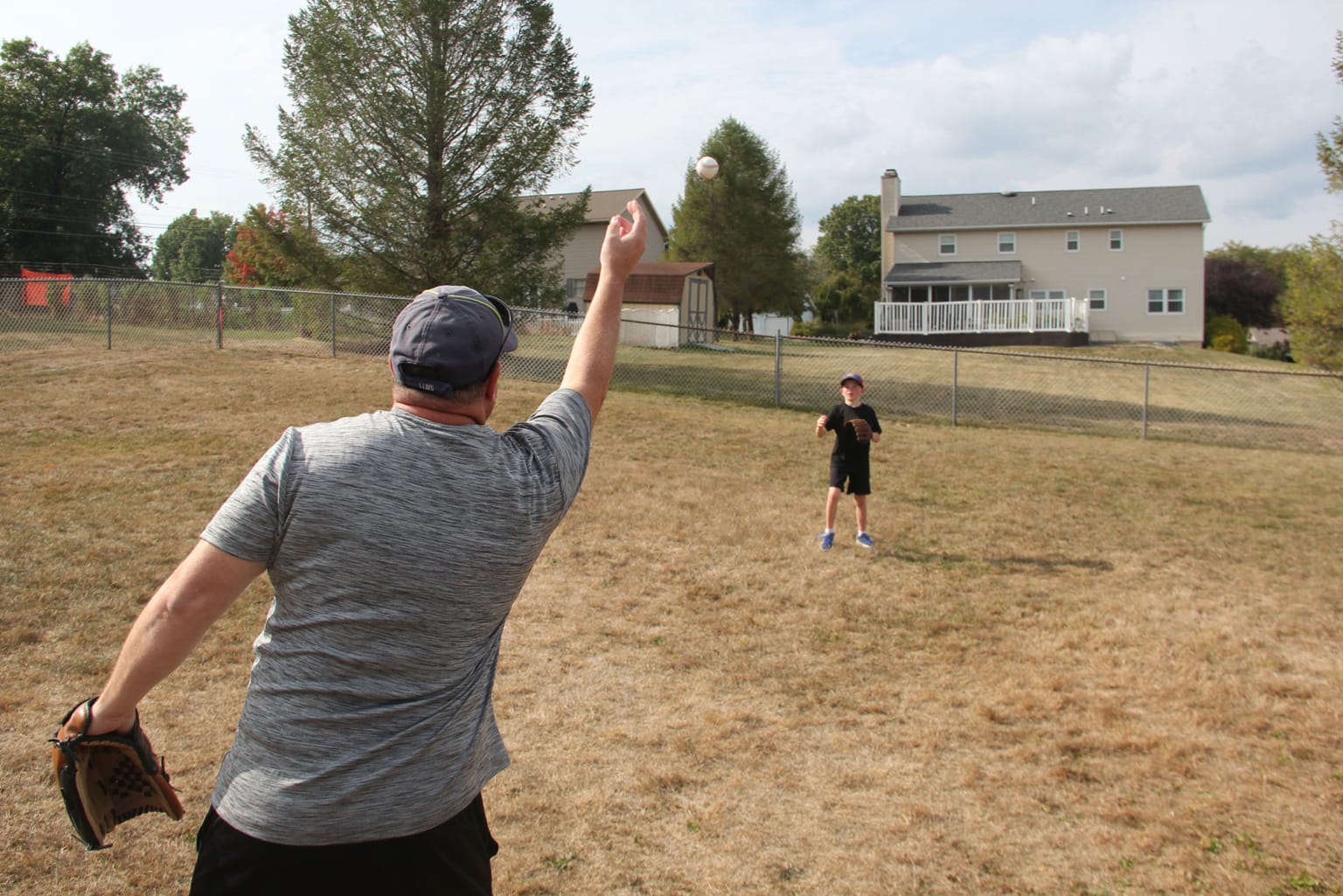 adult tossing ball