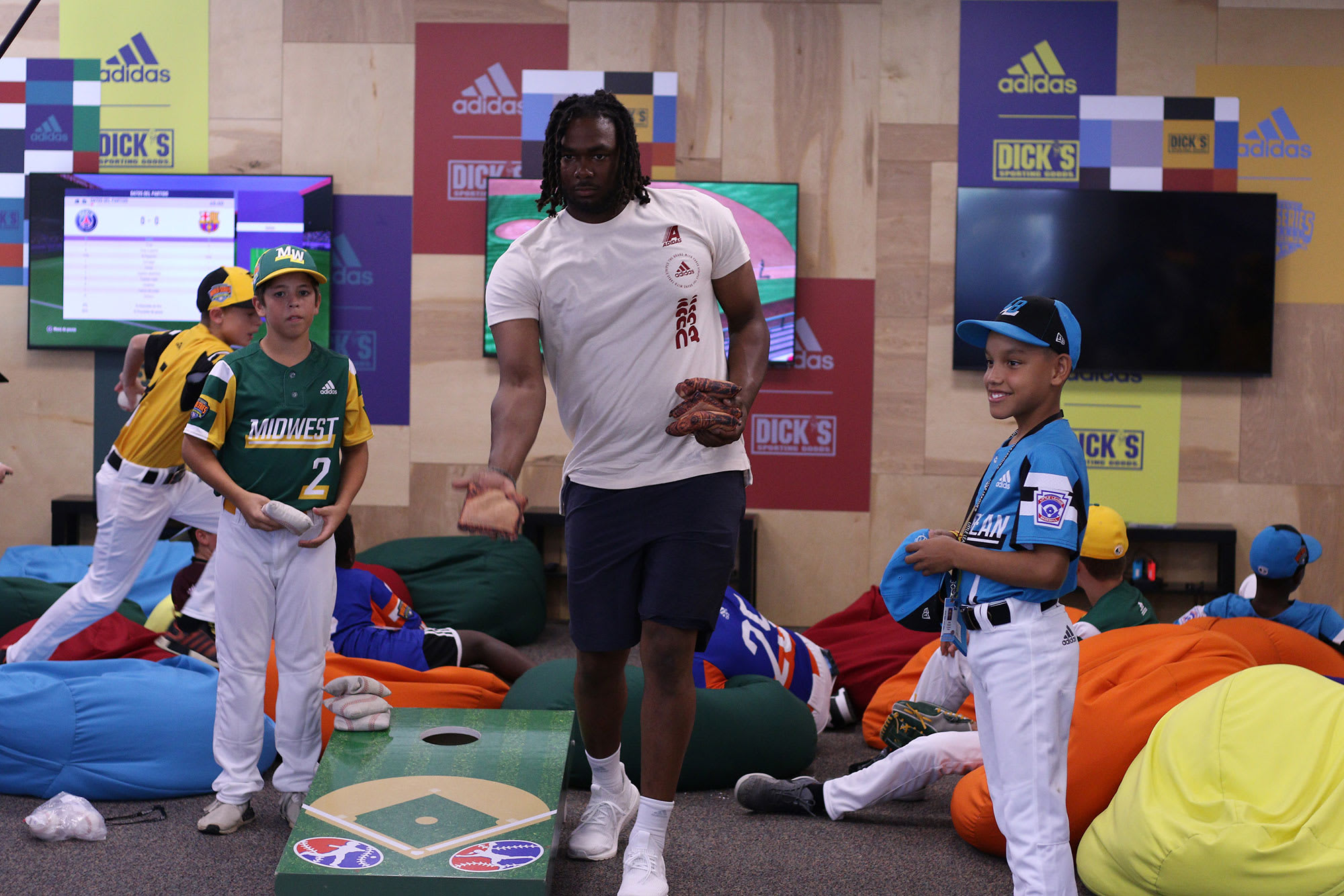 Pirates player playing cornhole with teams