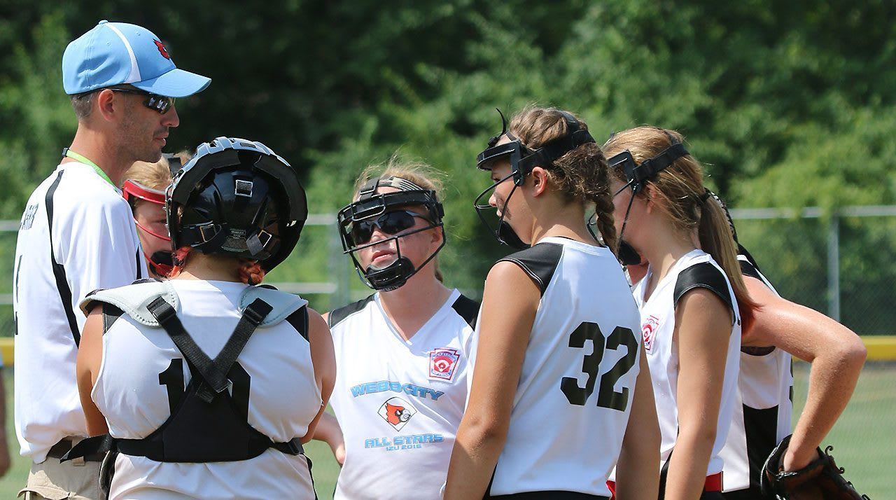Softball Player Huddle with Coach