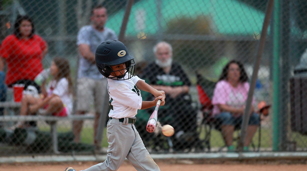 Baseball Player Hitting Ball