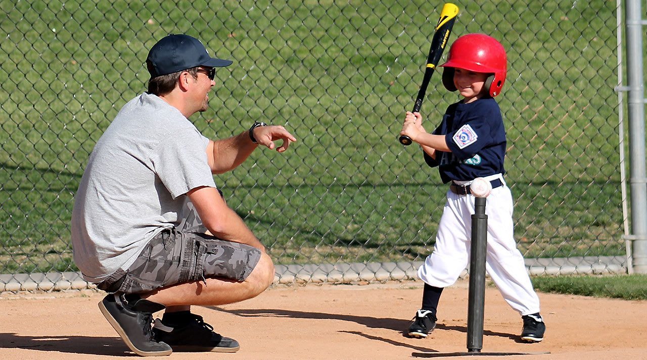 Father Coaching Tee Ball Player