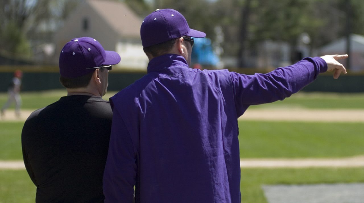 Coaches pointing to field