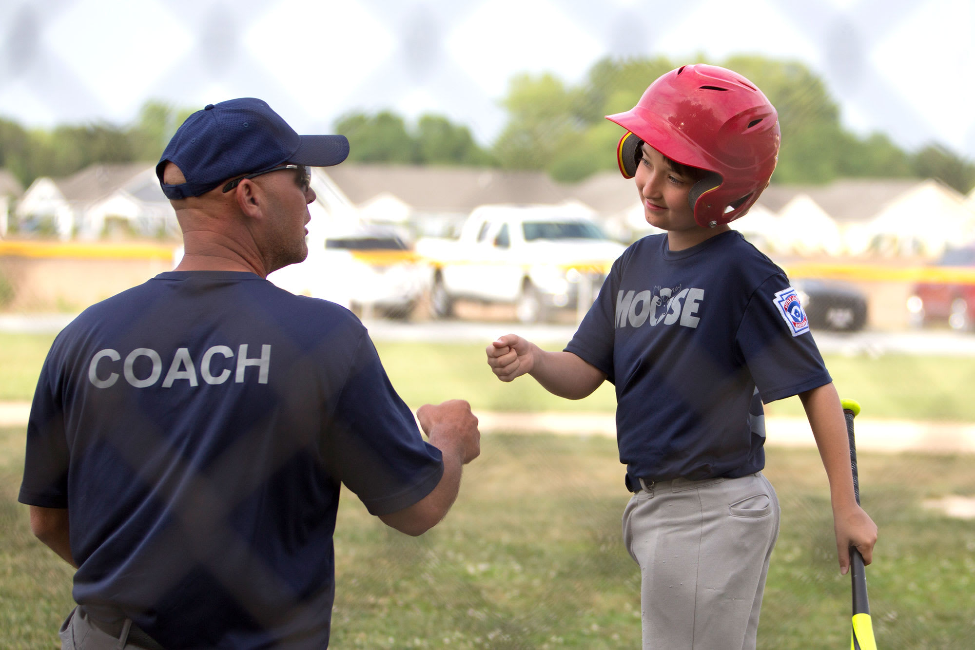 coach-kneeling-player-fist-bumping
