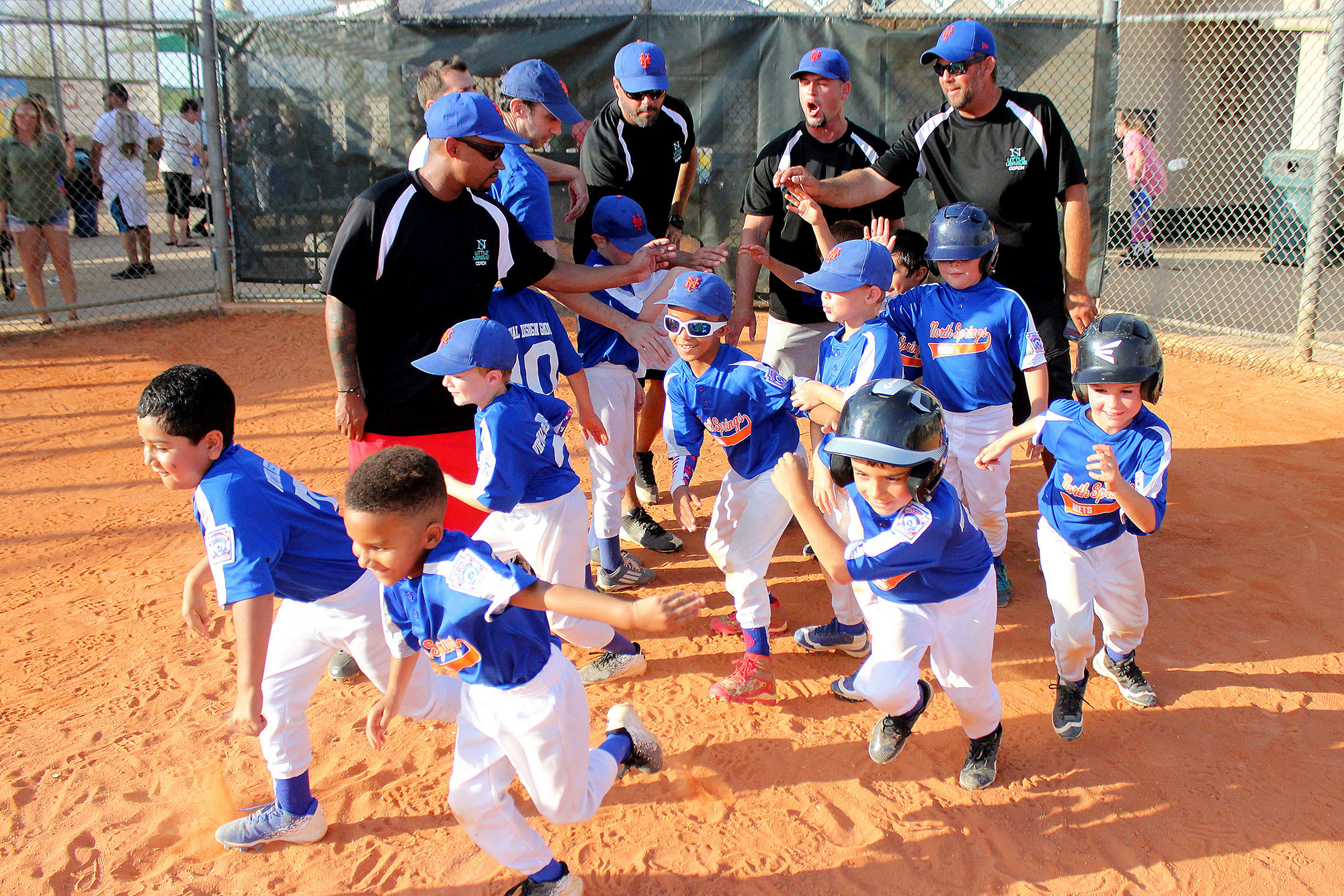 coaches-players-high-fiving-smiling