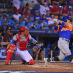 mets player swinging bat
