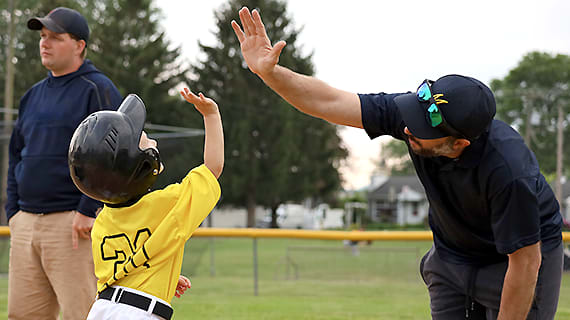 Tee Ball high five mike and TJ