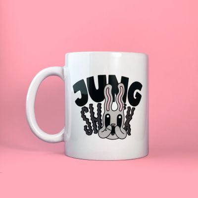 Front view of a mug with an illustration of a grey rabbit looking shocked. Jung Shook is drawn in black and grey letters behind the rabbit.