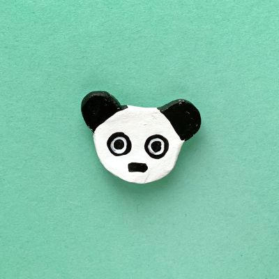 Panda with wide open eyes on green background