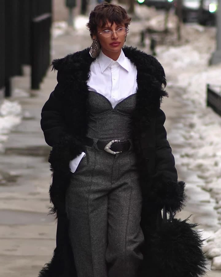 A shearling coat on a snow-lined sidewalk