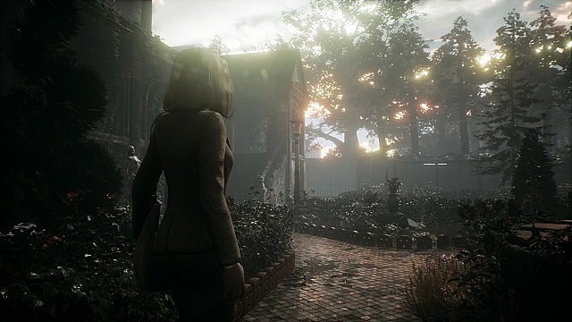 Reed stands in the garden outside the main house in Remothered
