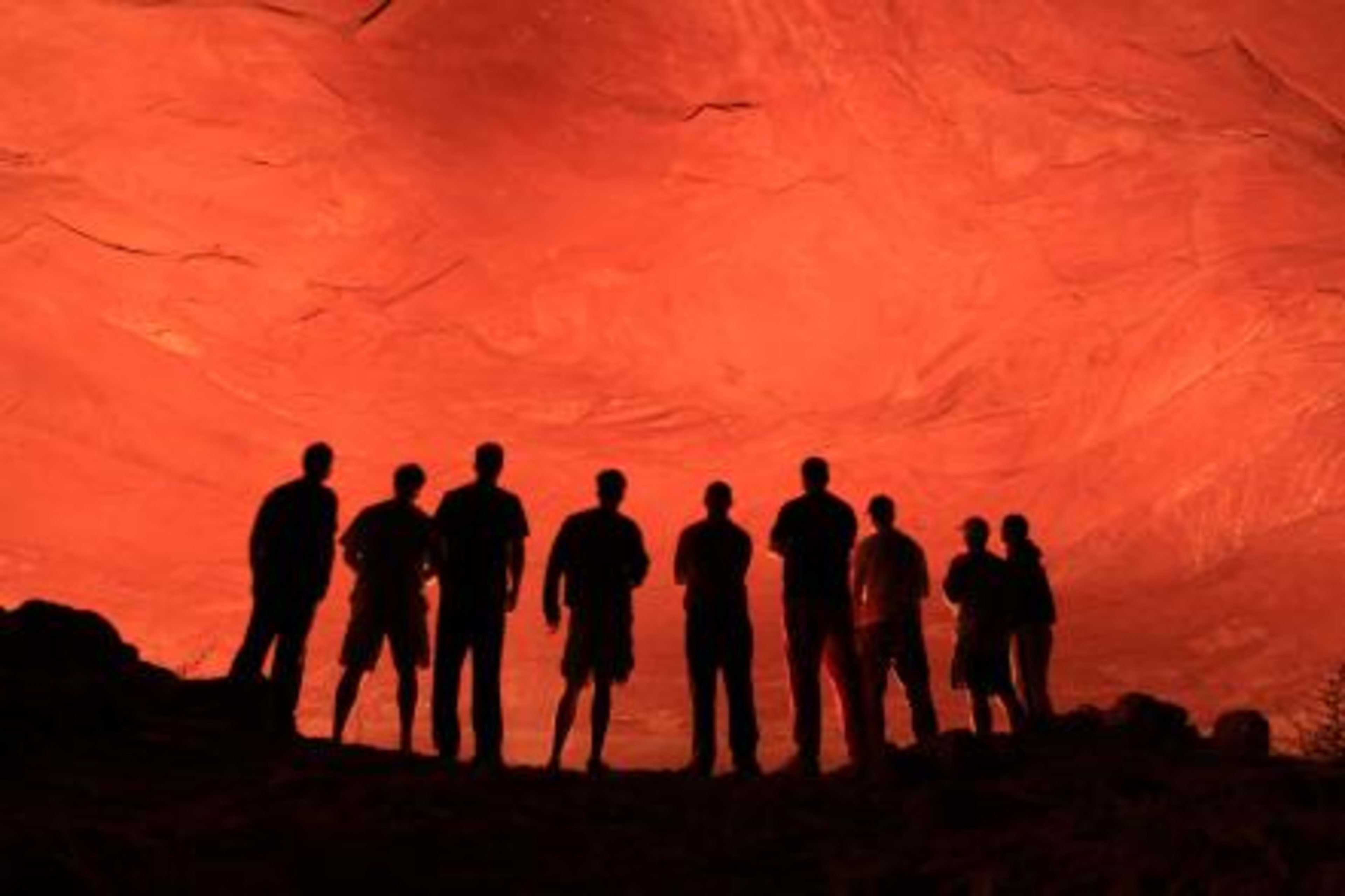 Bill's long-running entrepreneurs' forum, silhouettes against a red-rock wall. The right people compound over decades.