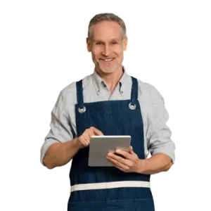 A Man In An Apron Holding A Tablet With A Friendly Smile, Ready To Assist Help-Seeking Individuals.
