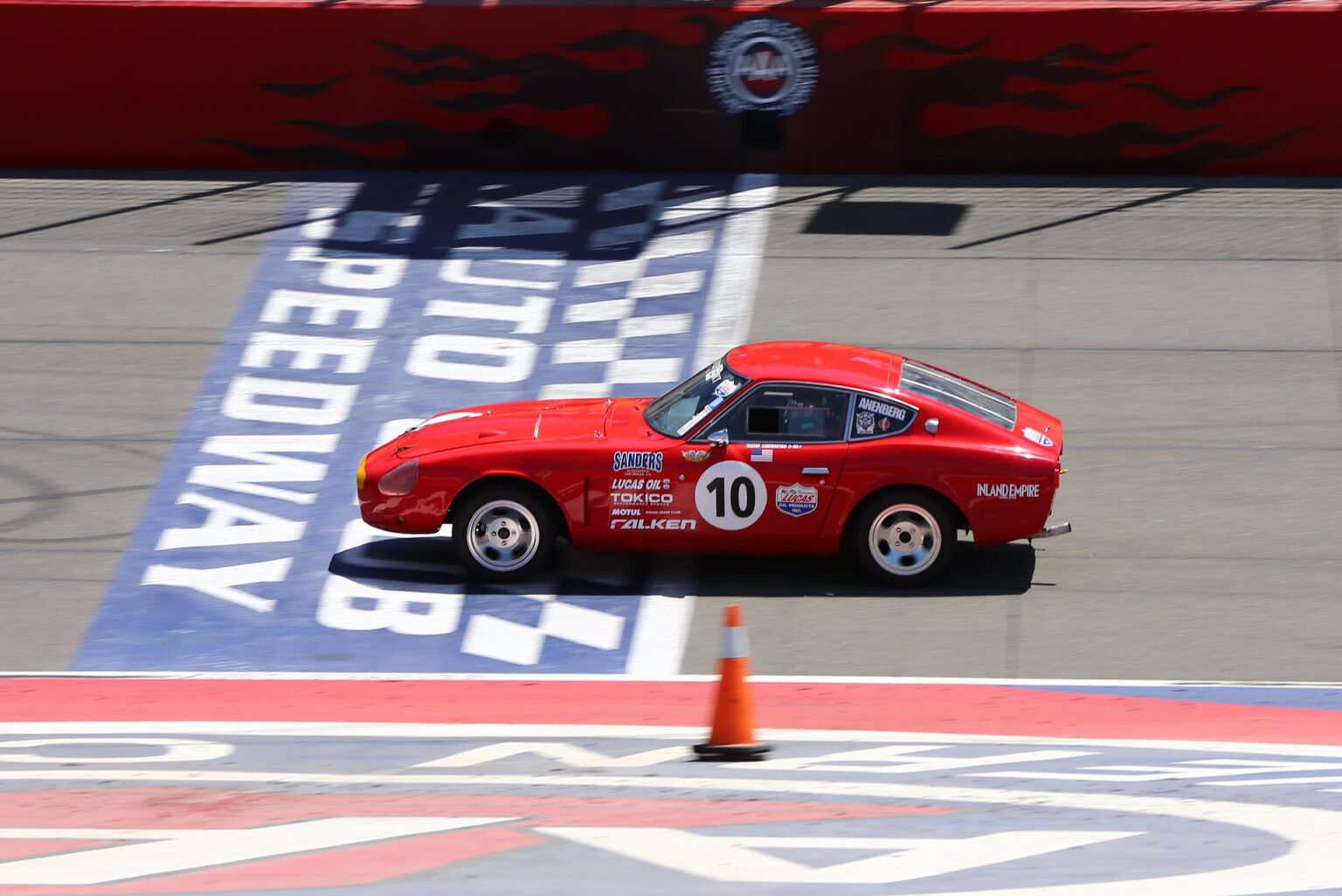 image of Hector's red highly-modified Z crossing the finish line at Auto Club Speedway