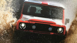 The INEOS Grenadier splashing through a huge puddle.