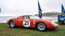 a red 1964 Ferrari LM Scaglietti Berlinetta on display at Pebble Beach