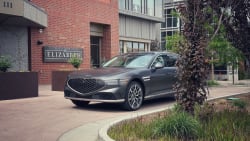 The 2023 Genesis G90 parked outside a luxury hotel