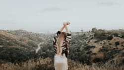 girl stretching with a view over Los Angeles