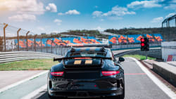 street car on a race track that looks like an F1 track