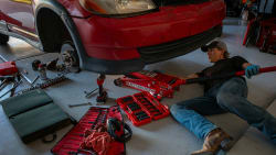person working on old car