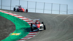 racers taking a corner at Allen Berg Racing School in Laguna Seca