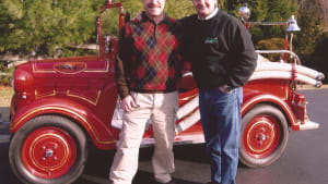 Dan Banks and our Hector Cademartori next to his 1939 Datsun fire truck, red of course.