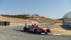 race cars driving through a corner at Laguna Seca