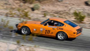 orange Datsun racing up a hill at the VARA Hillclimb in Willow Springs.