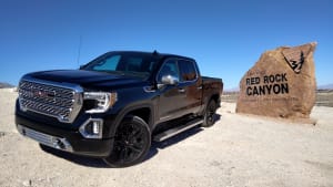 a black 2022 GMC Sierra 1500 Denali next to the sign for Red Rock Canyon