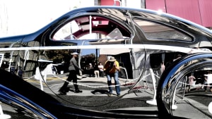 image of the side of a car at the concours d'Elegance on Rodeo Drive, with the author/photographer reflected on the door panel.